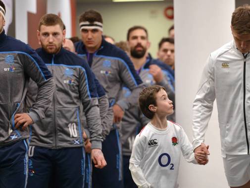 Dr Fairweather's son leads the England rugby team captain Owen Farrell out to a game against Scotland