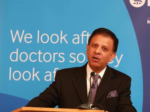Chaand Nagpaul in front of the We look after doctors banner