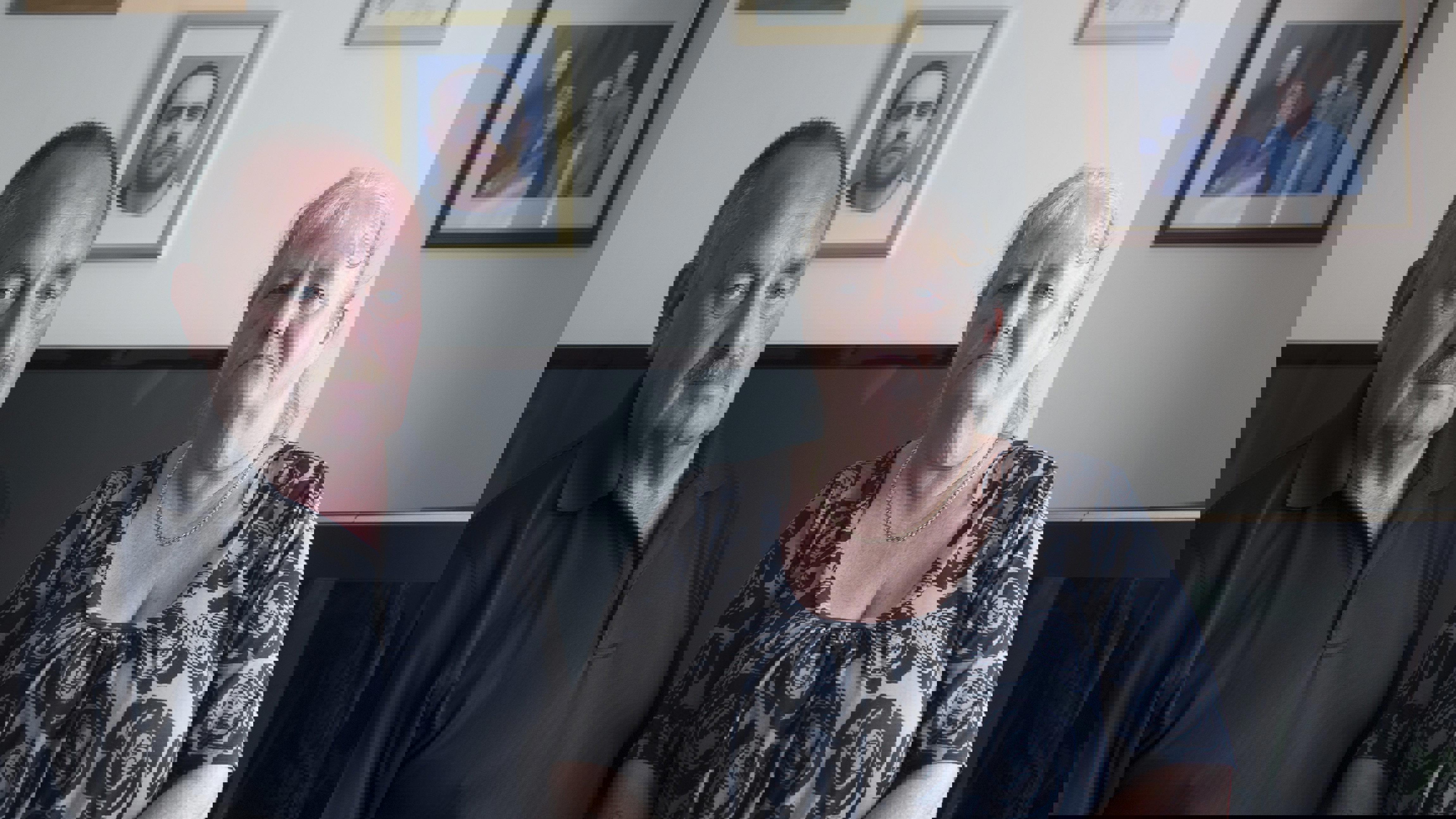 Portrait of Gerald Knight and Julie Nancarrow sat on a sofa in a living room looking to camera