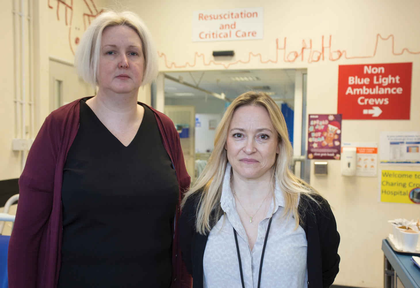 Two members of A&E stood together in a hospital setting looking to camera.