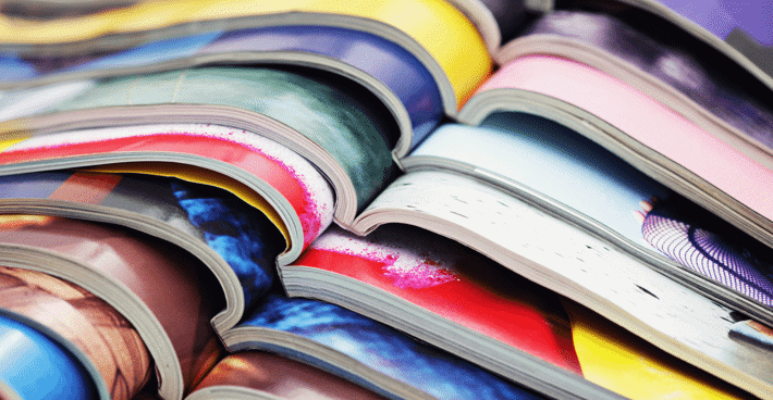 A detail of a stack of magazines staggered and lying open