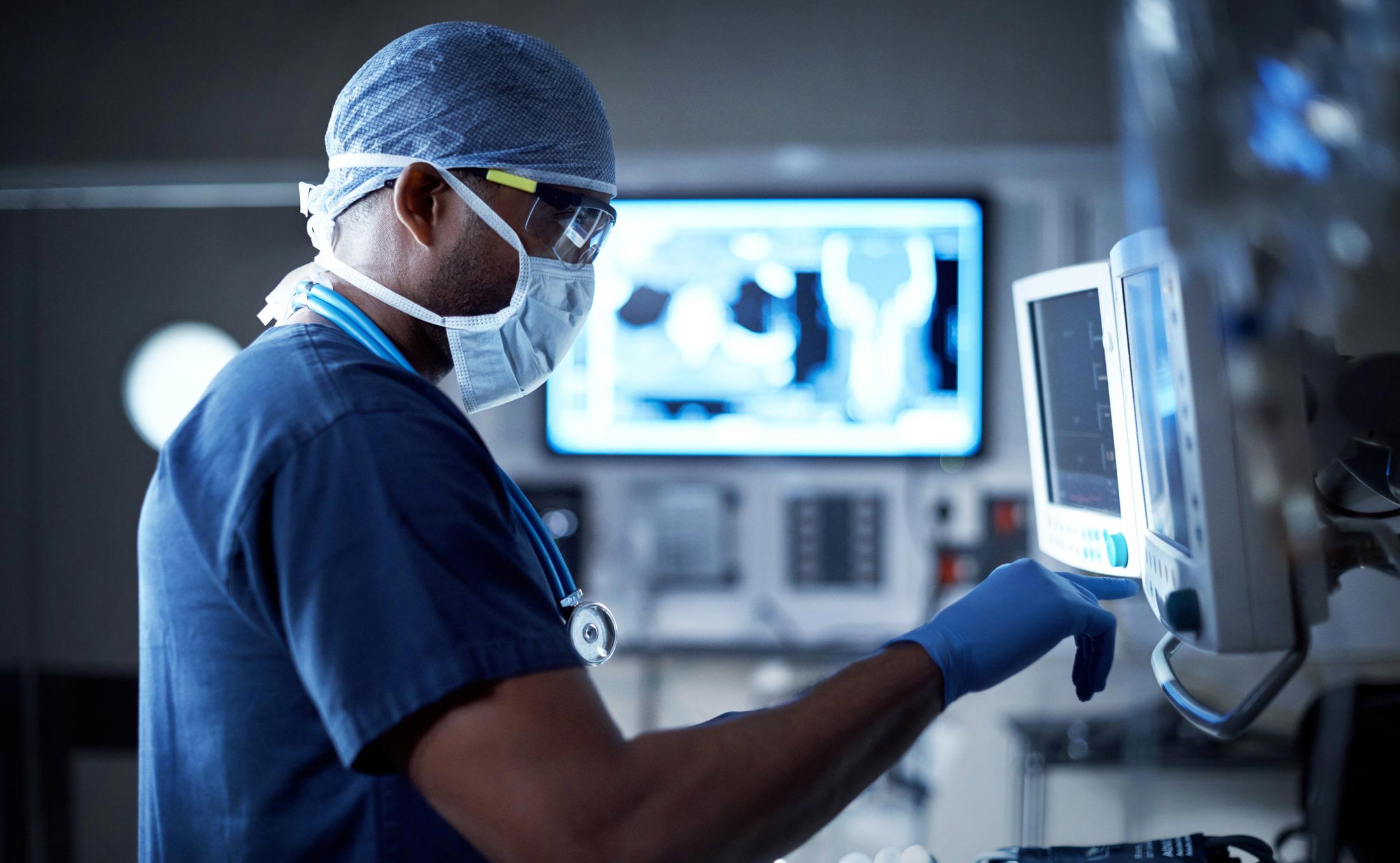 Doctor in scrubs using machine