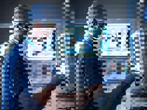 Doctor in scrubs using machine