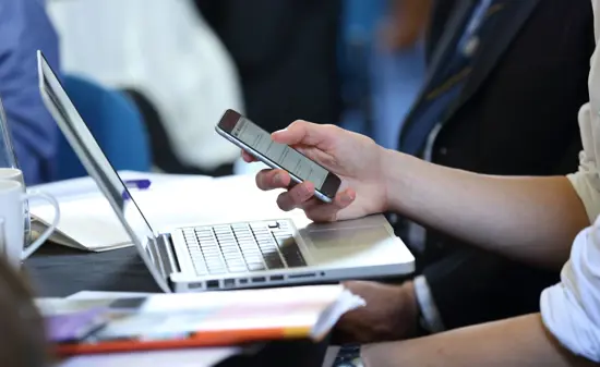 Laptop and mobile device at event