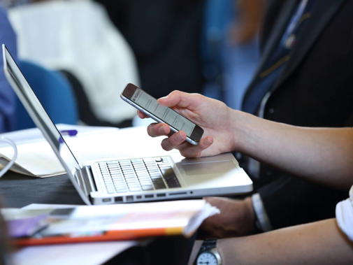 Laptop and mobile device at event