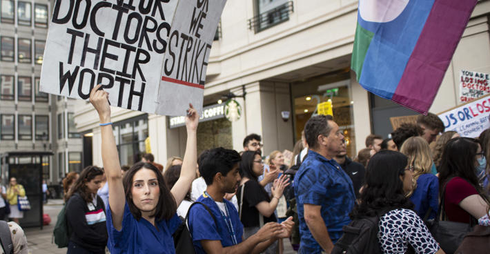 Protestors holding banner saying 'Pay junior doctors their worth'