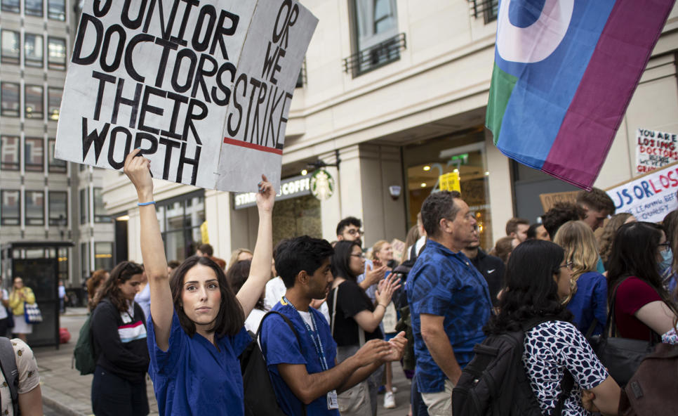 Protestors holding banner saying 'Pay junior doctors their worth'