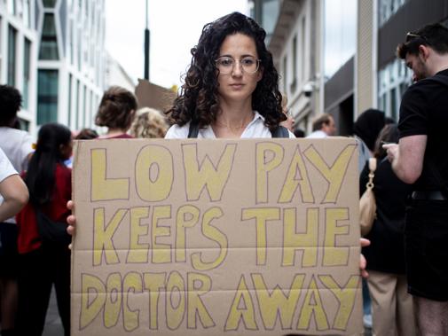 BMA Junior doctor pay protester with placard July 2022