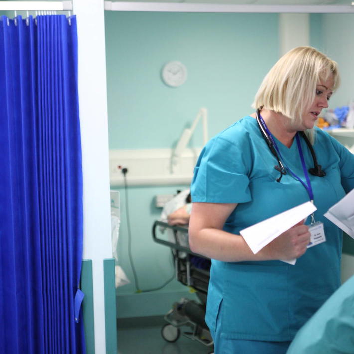 Female consultant with hospital paperwork