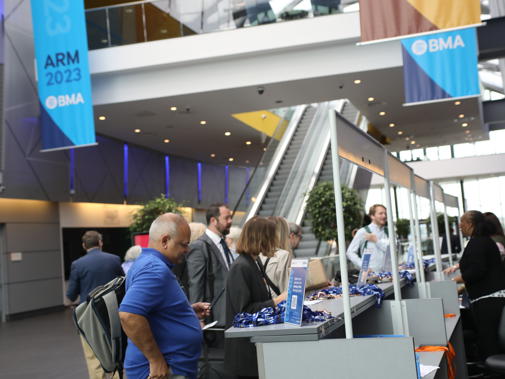 People beginning to arrive at the registration desk at ARM 2023 in Liverpool