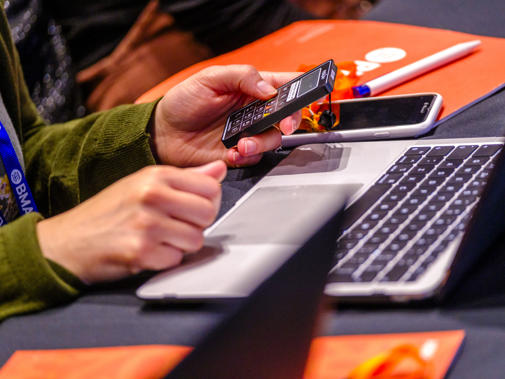 Hands voting on motions at ARM 2023